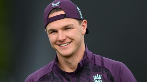 Sonny Baker, wearing a cap, smiles during England training