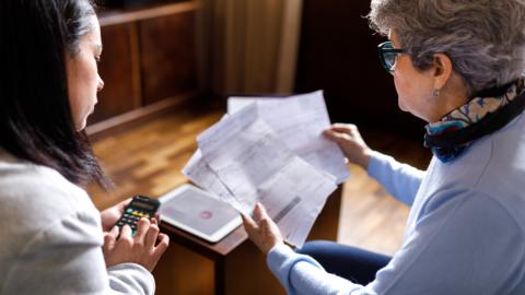 Women working out cost of bills