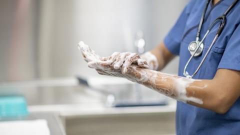 Stock image of a doctor washing their hands