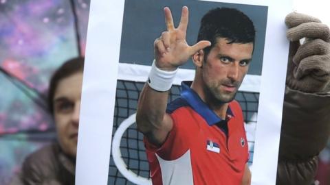 A supporter of Serbian tennis player Novak Djokovic holds a photo during a protest of support in Belgrade, Serbia, 08 January 2022.