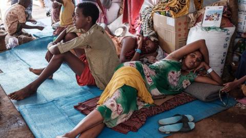 Ethiopian refugees who fled the Tigray conflict, rest in a makeshift shelter at Um Raquba reception camp in Sudan's eastern Gedaref state, on 3 December 2020