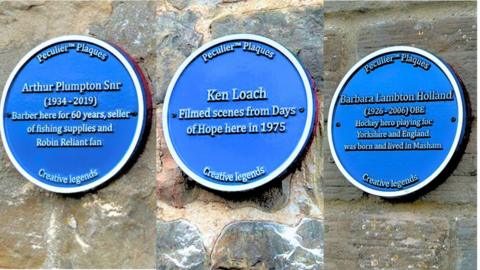 Three blue plaques on stone walls. The first one states Arthur Plumpton Snr (1934-2019) Barber here for 60 years, seller of fishing supplies and Robin Reliant fan. The second states, Ken Loach filmed scenes from Days of Hope here in 1975. The third states Barbra Lambton Holland (1926-2006) OBE Hockey hero playing for Yorkshire and England was born and lived in Masham. 