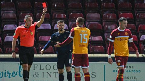 Motherwell's Dan Casey is shown a red card by referee Chris Graham during a William Hill Premiership match between Motherwell and Kilmarnock at Fir Park, on December 20, 2024, in Motherwell, Scotland