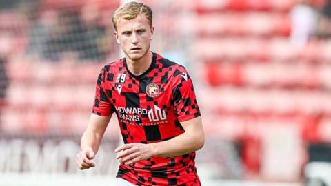 Ryan Finnigan warms up for Walsall ahead of a League Two match
