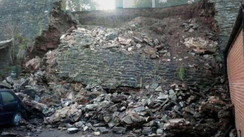 A collapsed stone wall that would have been around 25ft tall