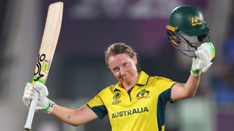 Australia captain Alyssa Healy raises her bat after making her sixth ODI century in their Women's World Cup match against India