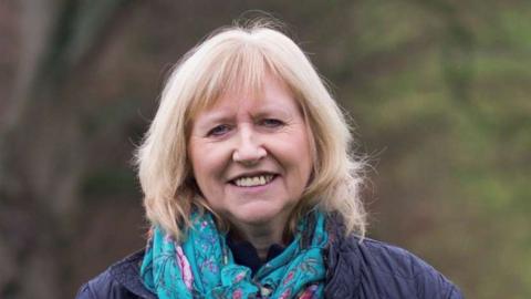 Judy Dilks, a dairy farmer from Derbyshire standing on her farm in Hassop.