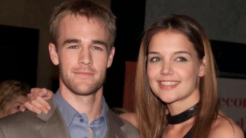 Katie Holmes with her arm around James Van Der Beek in 2002