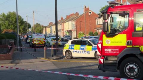A fire engine and police cordon at the scene
