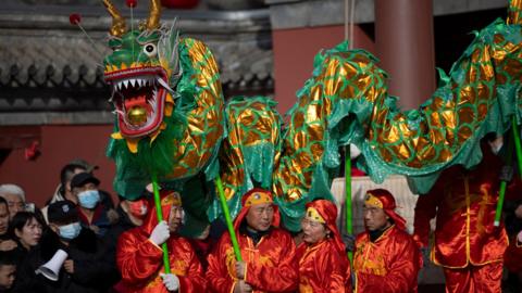 Performers in action during a Dragon Dance at the Dongyue Temple in Beijing, China