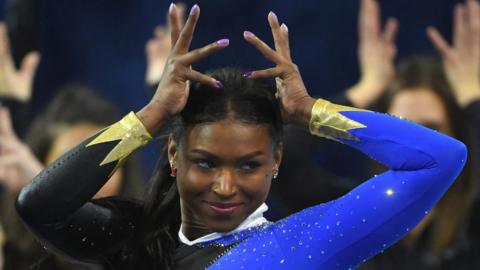 Gymnast Nia Dennis performed a routine to a medley of Beyonce music