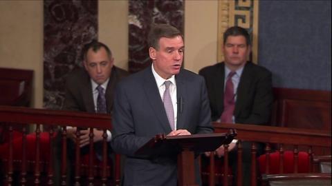 Mark Warner speaking at a podium