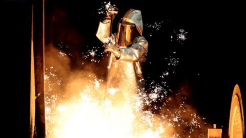 Steel worker takes a steel sample at a blast furnace in Duisburg, Germany