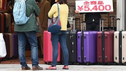 People looking at suitcases in Japan