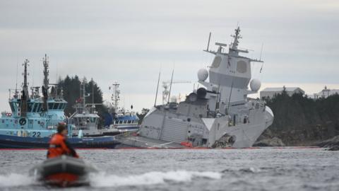 The Norwegian frigate KNM Helge Ingstad takes on water after colliding with the tanker Sola TS in the waters off Oygarden, Norway, 8 November 2018