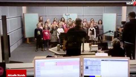Children's choir recording in a radio studio