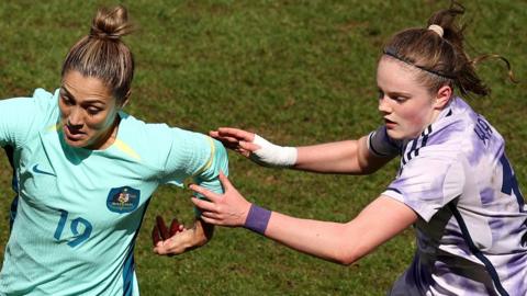 Katrina Gorry of Australia battles for possession with Scotland's Emma Watson