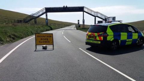 Police car parked on closed road