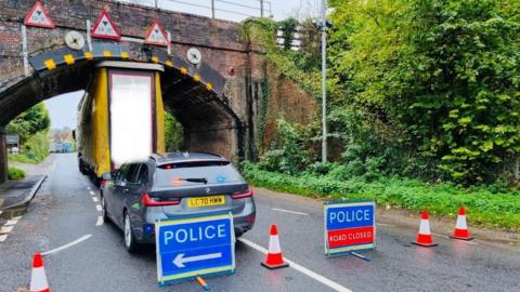 A lorry trapped beneath a railway bridge