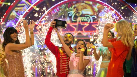 Aston Merrygold and Janette Manrara lift the trophy