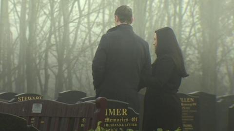Couple at their child's grave