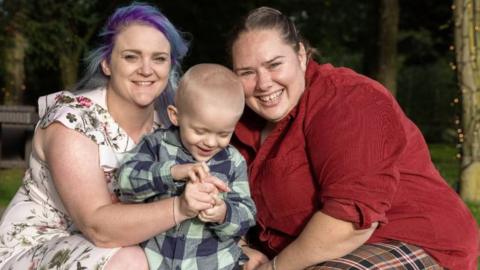 Albie with his mothers Lauren and Hayley