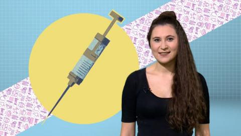 Woman standing next to an illustration of a flu vaccine