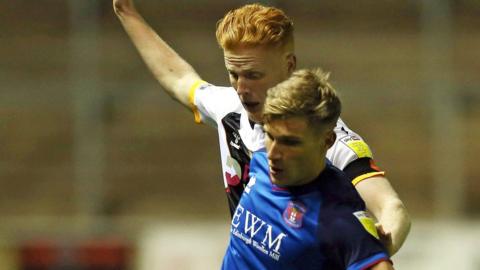 Gavin Reilly of Carlisle United and Ryan Haynes of Newport County