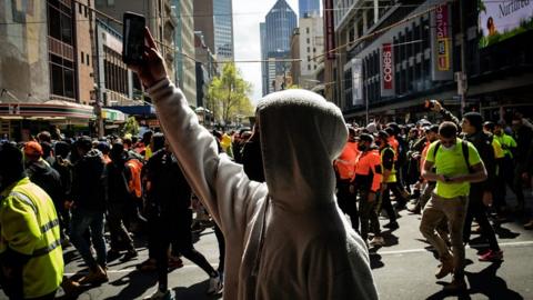 Man walks in Melbourne protest