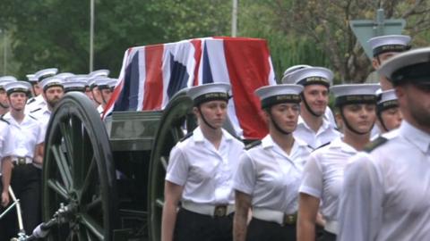 Naval officers with the gun carriage