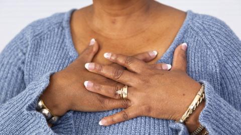 Woman clutching heart