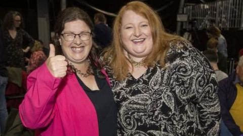 Naomi Long (right) celebrating with her party colleague Kellie Armstrong