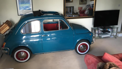 Teal Fiat 500 in the living room