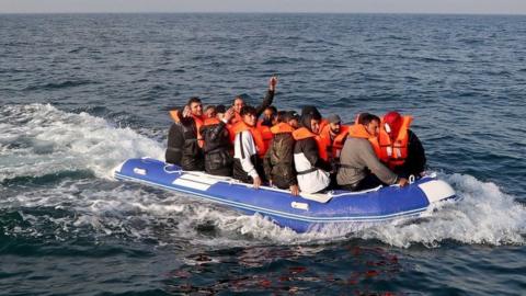 A group of people thought to be migrants crossing the Channel in a small boat headed in the direction of Dover, Kent.