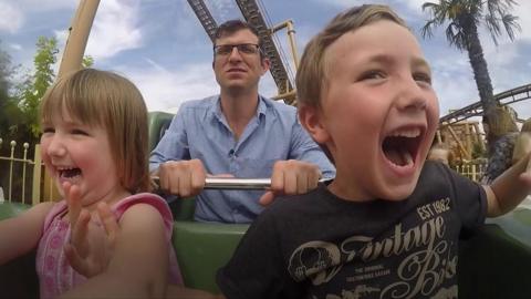 Family enjoy theme park ride