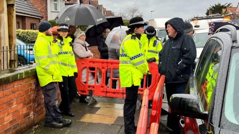 Police in attendance as residents blockade a road in Southport