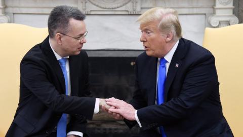 Andrew Brunson, left, in the Oval Office with President Donald Trump