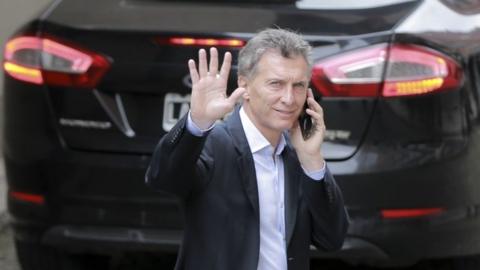Argentina's President-elect Mauricio Macri waves to journalists after a press conference in Buenos Aires, Argentina, on 23 Nvember, 2015.
