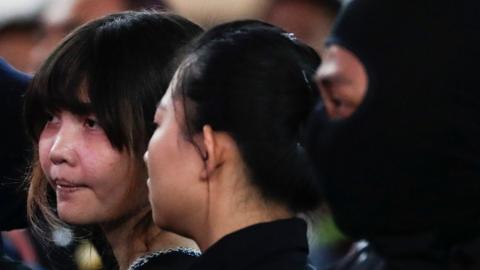 Doan Thi Huong (L) of Vietnam - who is on trial for the assasination of Kim Jong-nam, the estranged half-brother of North Korea"s leader Kim Jong-un - is escorted as she revisits scene of the attack at Kuala Lumpur International Airport 2 in Sepang, Malaysia, 24 October 2017.