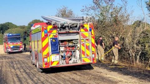 Firefighters at a field fire in near Sudbury, Suffolk