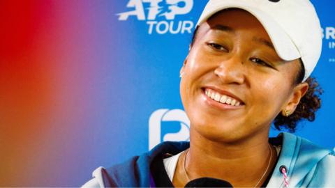 naomi osaka smiles at a news conference