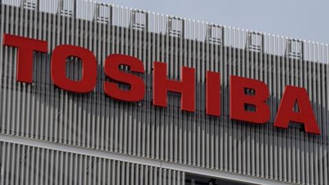 A Toshiba company logo appears on a building in Tokyo