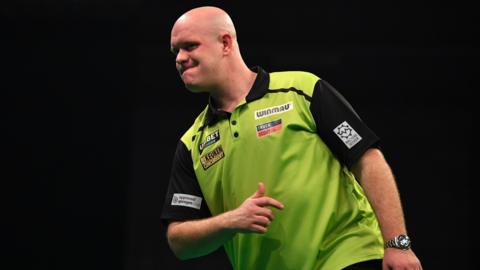 Michael van Gerwen reacts during a darts match