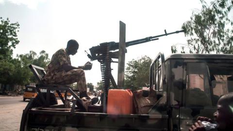 A soldier sits on the back of an armed vehicle in Maiduguri in north-eastern Nigeria on July 7, 2017