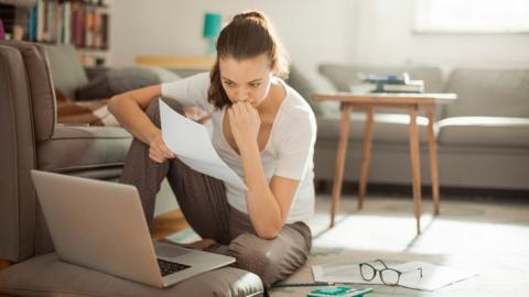 Woman looking at laptop