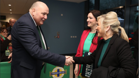 Irish Football Association president Conrad Kirkwood greeted Michelle O'Neill and Emma Little-Pengelly on their arrival