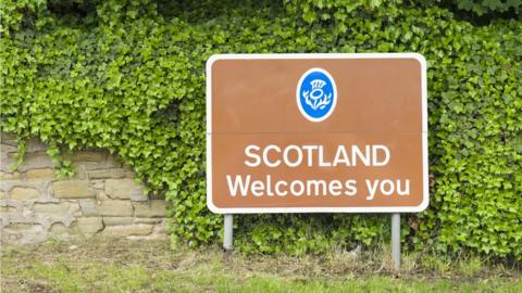 Sign saying Scotland Welcomes You