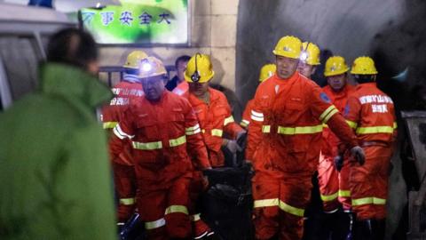 Rescuers carry a victim at the site of a coal mine explosion in Pingyao, early on November 19, 2019
