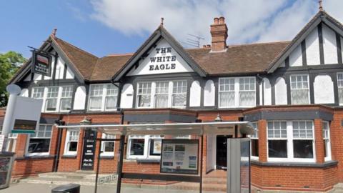 a pub with beams on the outside