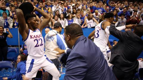 De Sousa holds a chair up during the brawl